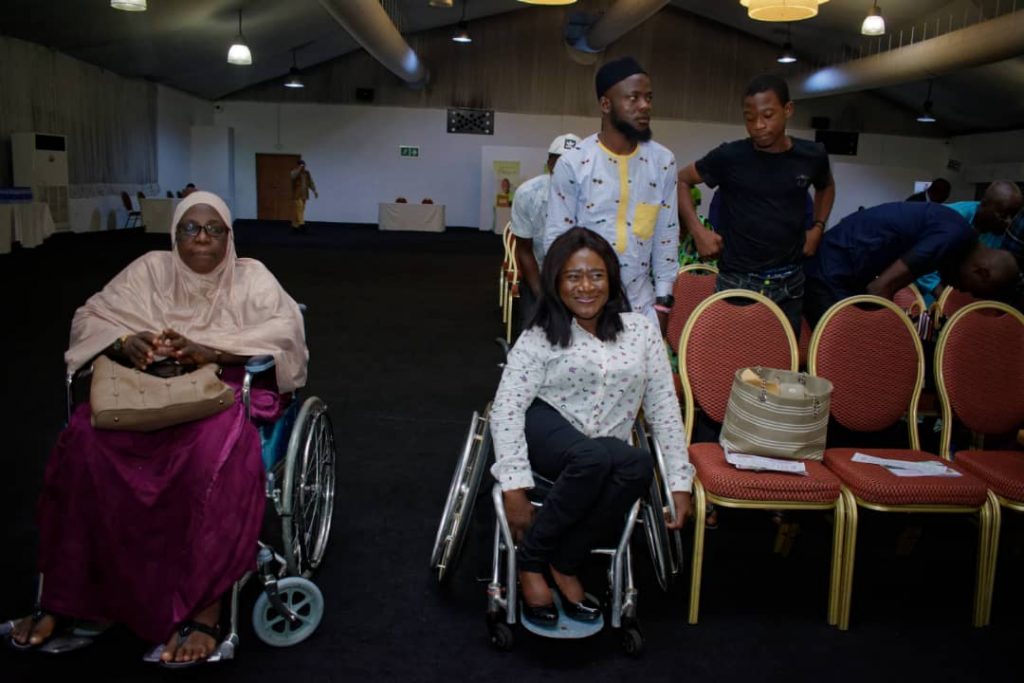 Image of two ladies Sitting on a wheelchair at an event
